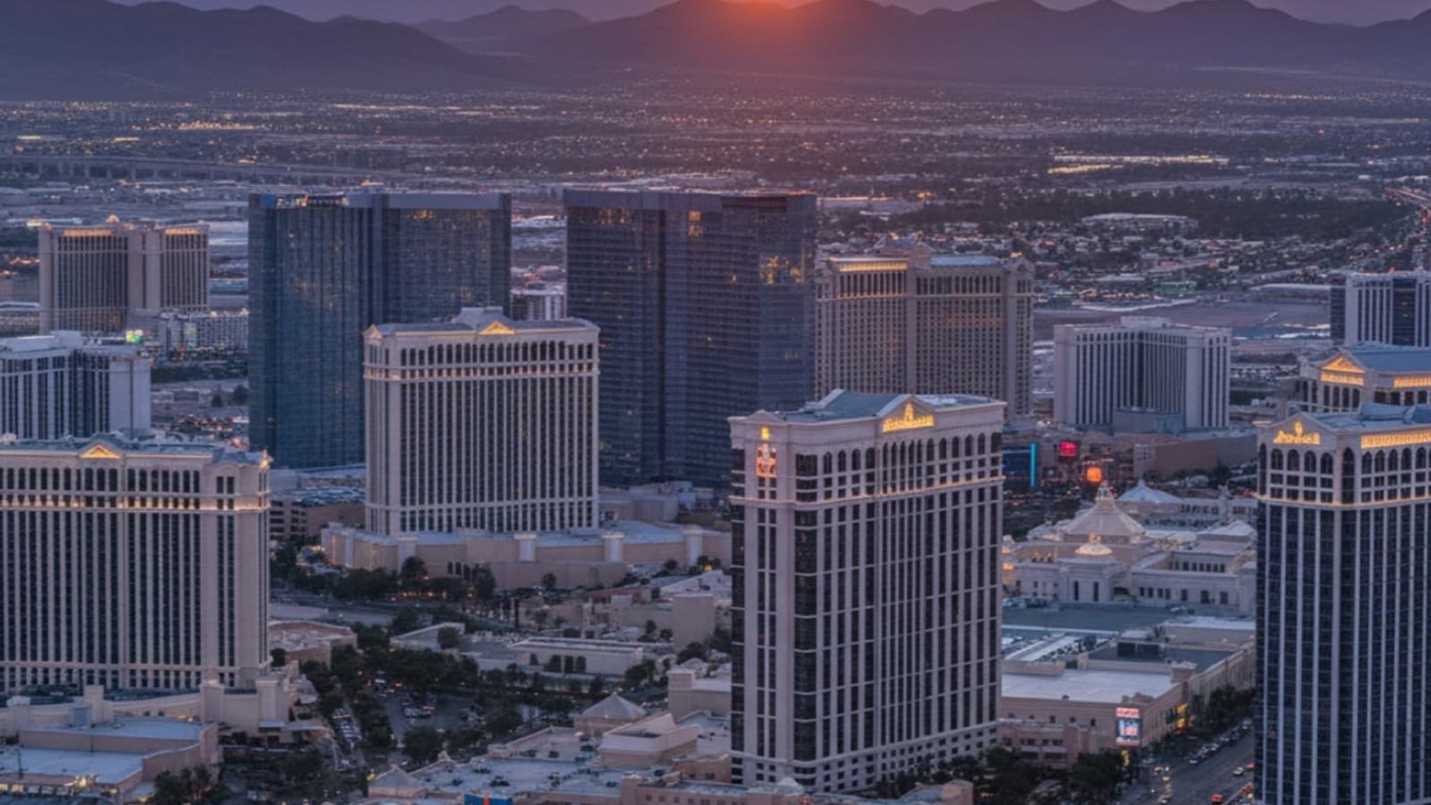 Las Vegas apartment complex at dusk with Strip skyline visible — average rent in Las Vegas 2026 market guide